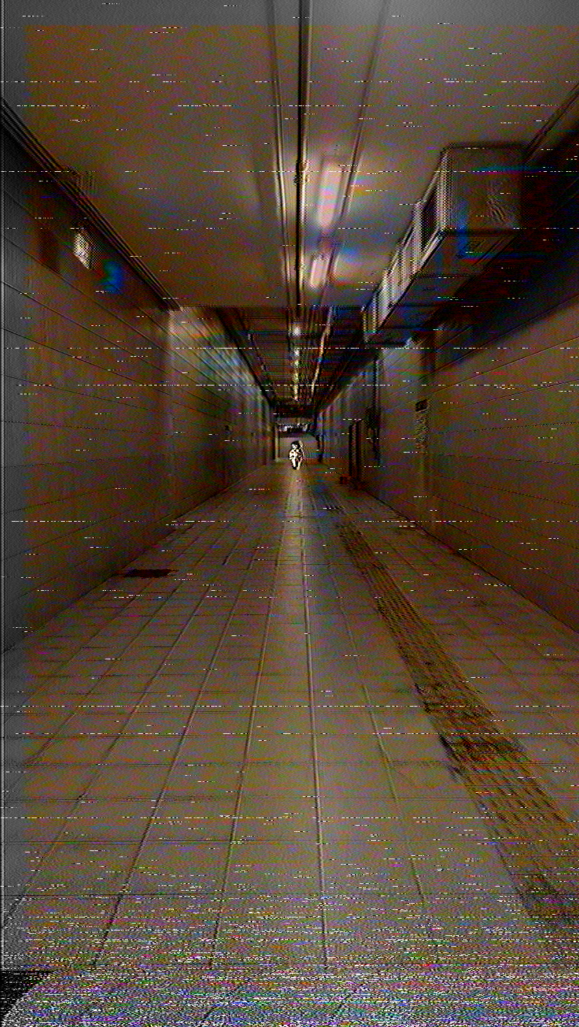 She is going down a corridor.